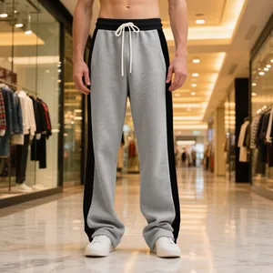 Close-up view of grey and black color-block men's straight leg fleece sweatpants in a mall