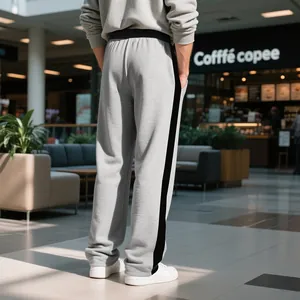 Detailed back view of men's grey sweatpants featuring a contrast black side stripe.