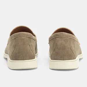 Rear view of stylish khaki suede men's slip-on loafers with durable white soles.