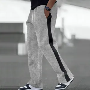 Detailed view of men's grey sweatpants featuring heavy terry fabric and black side stripes.