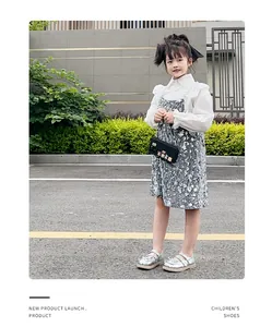 Full body shot of girl wearing silver metallic Mary Jane princess shoes outdoors