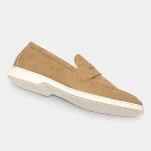 Side view detail of men's casual brown suede penny loafers featuring white rubber soles