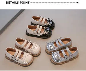 Detailed macro view of stylish girls' Mary Jane shoes in silver, cream, and black finishes.