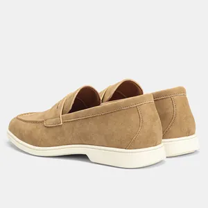 Back angle detail of men's tan suede-like casual loafers featuring a durable white sole