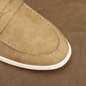 Close-up of tan suede loafer showing fine stitching and premium leather texture.