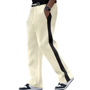 Detail view of cream heavy loopback sweatpants with black side stripe and loose straight fit.