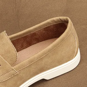 Detailed macro view of the suede texture and padded collar of a tan men's loafer shoe