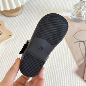 Durable anti-slip sole of black girl's Mary Jane shoe showing size 23 and grip texture