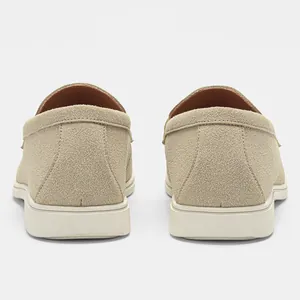 Rear view detail of men's beige suede loafers with durable white rubber soles