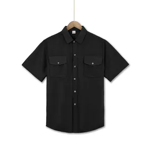 Detailed view of black short-sleeve shirt with double chest pockets and grid texture.