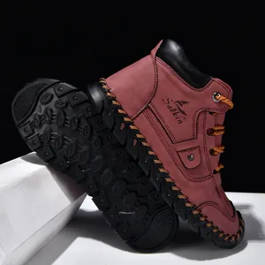Close-up of maroon men's leather boots with manual stitching and non-slip sole detail