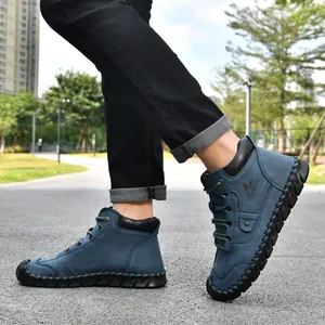 Detailed view of blue leather men's ankle boots with handmade stitching details
