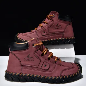 Close-up view of men's hand-stitched leather ankle boots with a flat lace-up design.