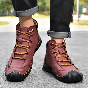 Detail view of men's leather ankle boots featuring hand-stitched seams and rope laces