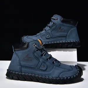 Detail of blue leather ankle boots with intricate hand-stitched seams and lace-up design