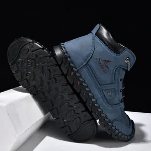 Close-up showing the hand-stitched sole and blue leather texture of men's ankle boots