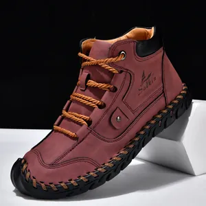 Close-up of men's burgundy leather ankle boots with decorative hand-stitching