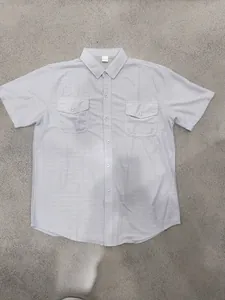 Light grey short sleeve button-up shirt with double chest pockets and subtle grid pattern