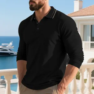 Detail of black long-sleeved polo shirt with striped collar on a luxury balcony.