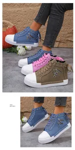 Detailed macro view of colorful women's high-top canvas sneakers with zipper and heart charms