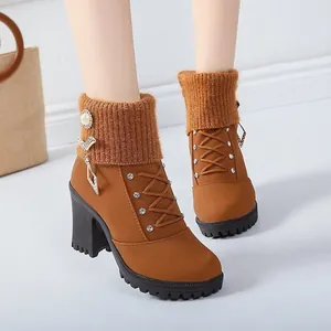 Close-up of brown chunky heel ankle boots with rhinestone accents and knitted cuffs