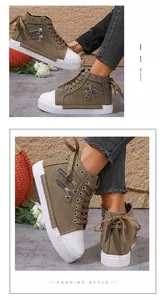 Detailed view of women's high-top canvas sneakers featuring side zippers and heart charms