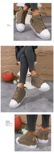Detail view of khaki high-top canvas sneakers with side zipper and heart charm