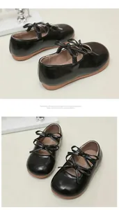 Detailed view of black patent leather Mary Jane shoes for girls with elegant bow accents