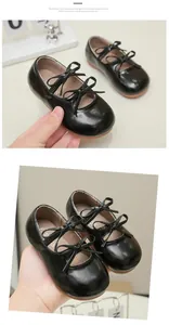 Close-up of black patent leather Mary Jane shoes for girls with double bow straps