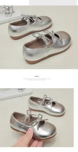 Detailed close-up of silver shiny girls Mary Jane princess ballet flats with bows