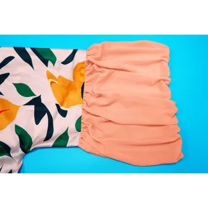 Détail en gros plan de la manche en mousseline à volants sur un cache-maillot fleuri.