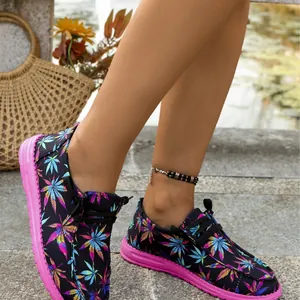 Fashionable women's colorful leaf print canvas flats featuring pink soles and casual lace-up style