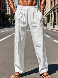 Detail of white cotton linen trousers with drawstring waist and straight leg cut