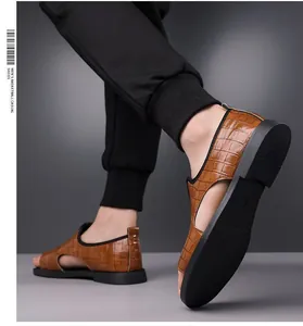 Close-up of stylish men's brown crocodile embossed Roman sandals with open toe design