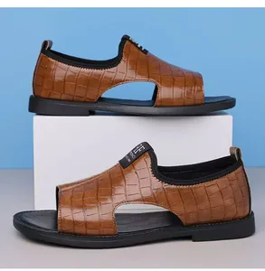 Side view of stylish men's brown embossed leather Roman sandals on a white block