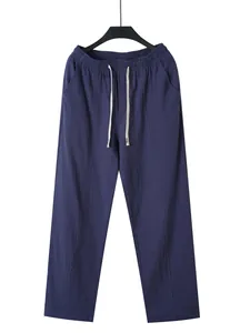Detailed view of navy blue men's breathable cotton linen trousers with drawstring waist.