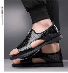 Side detail of men's black crocodile embossed Roman sandals featuring an open-toe summer design