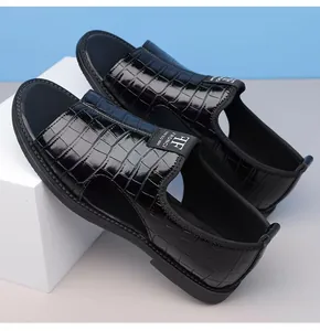 Close-up detail of men's black crocodile embossed Roman sandals with stylish brand tag