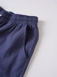 Close-up of drawstring elastic waist and side pocket on men's blue linen trousers