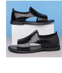 Macro detail of black crocodile embossed men's Roman sandals with open toe design for summer.