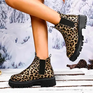 Stylish leopard print Chelsea boots for women with thick lug sole in snow setting
