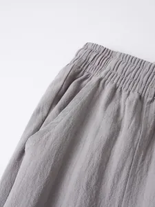 Close-up detail of elastic waistband and pocket on men's breathable cotton linen pants.