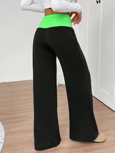 Back view of wide-leg yoga pants featuring a vibrant neon green high-waist band.
