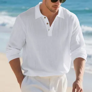 Close-up of a white men's long sleeve linen polo shirt at a sunny beach