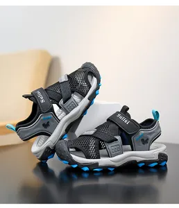 Detail of breathable black mesh boys closed-toe sports sandals with blue accents.