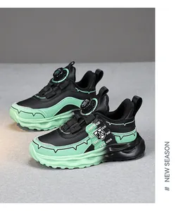 Detailed view of children's running shoes with rotary buckle in black and mint green