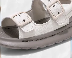 Detail shot of white kids' sport sandals with textured leather and adjustable buckles