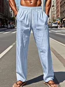 Light blue linen trousers for men with drawstring waist in an urban street setting