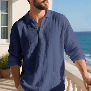 Men's navy blue long-sleeve linen polo shirt worn by a model in a seaside setting