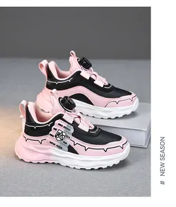 Close-up of stylish children's running shoes in pink and black with rotary dial closure